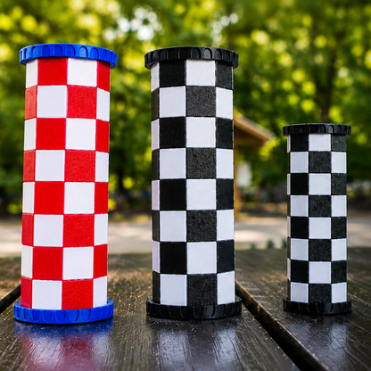 Travel chess set with checkered pieces on a wooden surface outdoors.