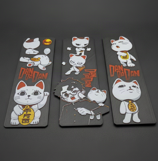 Three Dandadan Turbo Granny 3D-printed bookmarks on a dark gray studio background