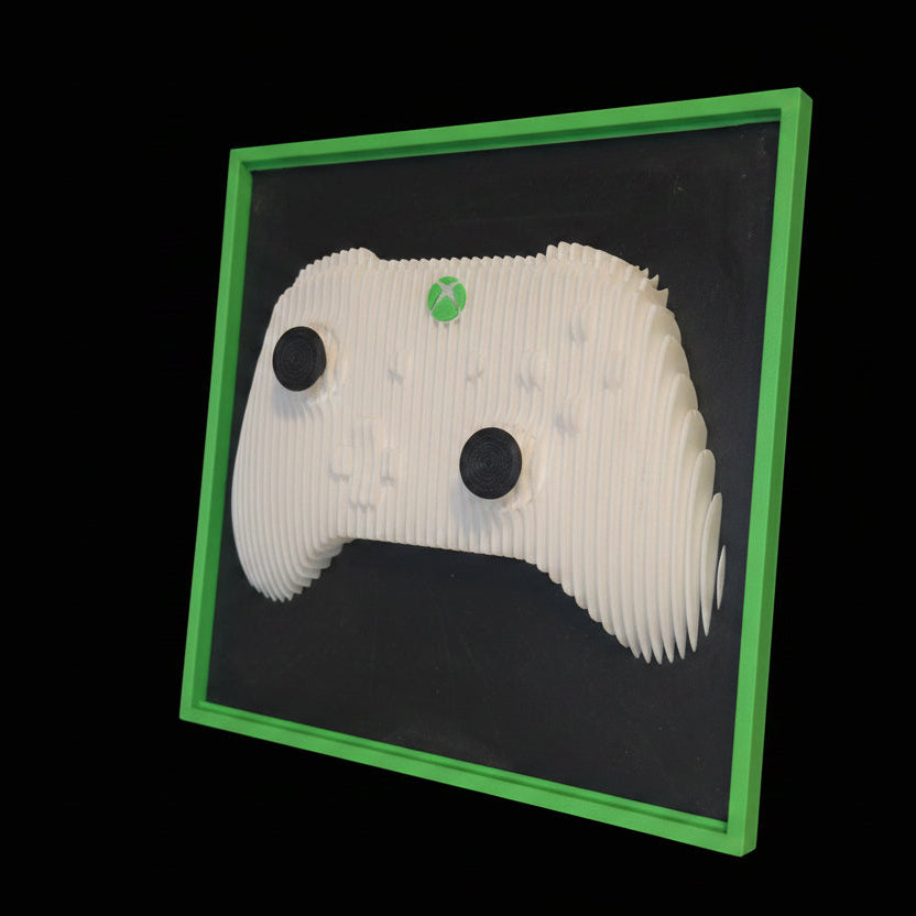 White paper sculpture with black dots on a black background framed by a green border.